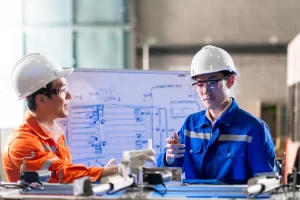Engineers having a discussion about a mechanical part in a factory
